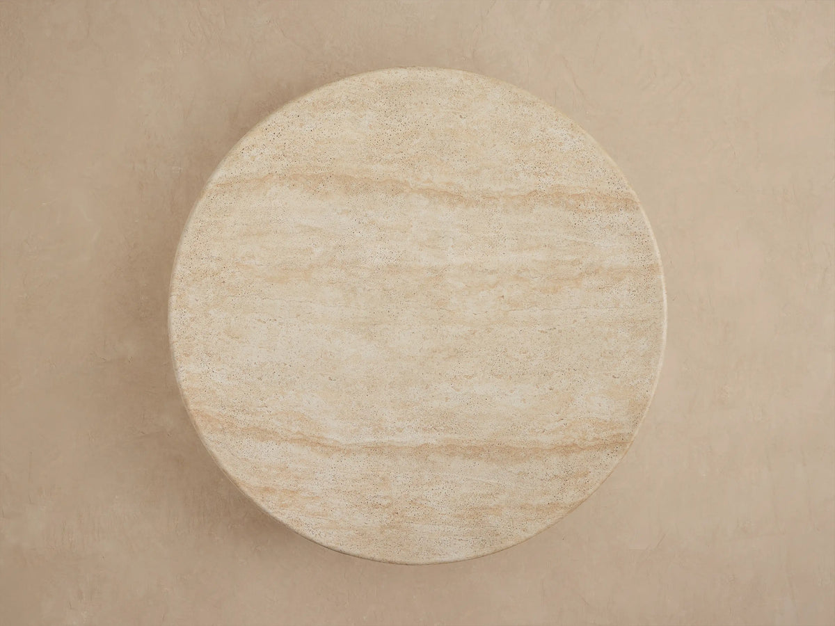 Close-up of Azores Outdoor Round Coffee Table, light beige faux travertine with subtle veining and textured surface.