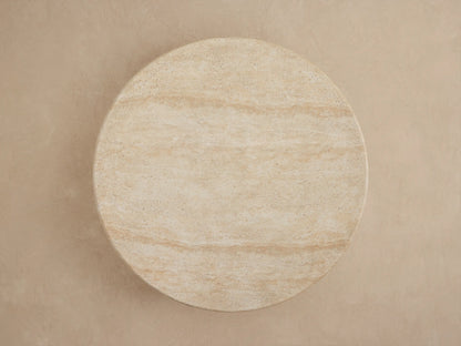 Close-up of Azores Outdoor Round Coffee Table, light beige faux travertine with subtle veining and textured surface.
