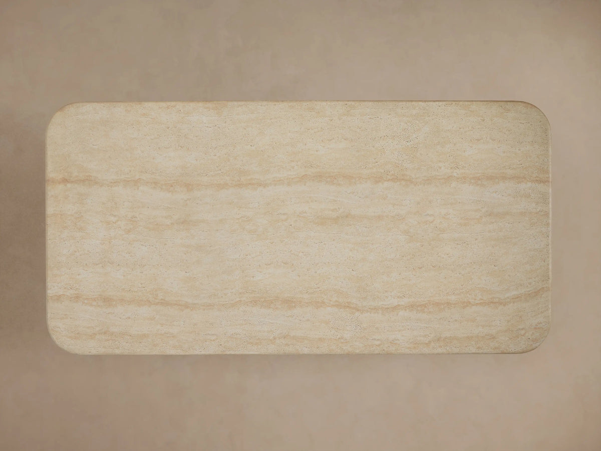 Close-up of Azores Outdoor Coffee Table with beige faux travertine finish, showing natural veining, speckles, and rounded edges.