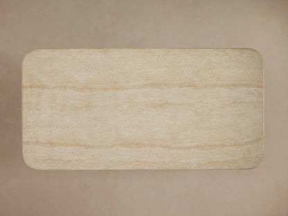 Close-up of Azores Outdoor Coffee Table with beige faux travertine finish, showing natural veining, speckles, and rounded edges.
