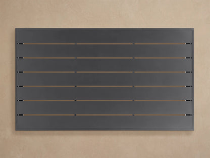 Angled close-up of a dark grey Bal Harbour Outdoor Aluminum Coffee Table, showing its slatted top and solid matte side panel.