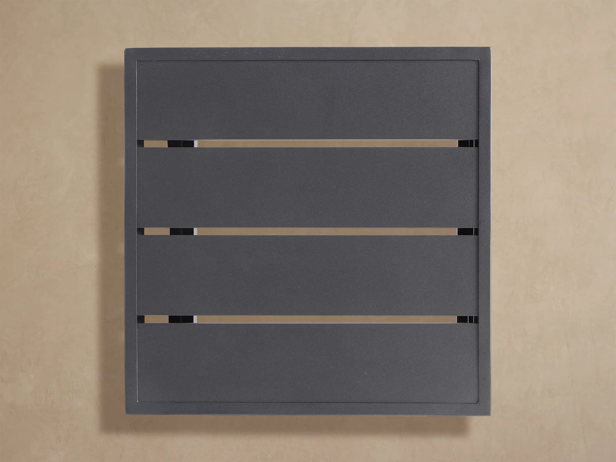 Angled close-up of dark gray Bal Harbour Outdoor Aluminum End Table. Top has parallel indented lines and textured finish.