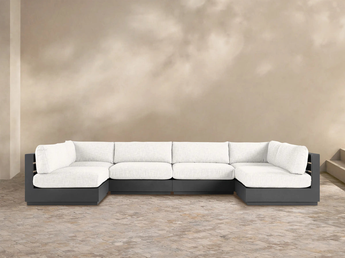 U-shaped Bal Harbour Outdoor Six-Piece Sectional with dark gray aluminum frame & light gray cushions on a paved patio.