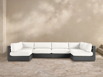 U-shaped Bal Harbour Outdoor Six-Piece Sectional with dark gray aluminum frame & light gray cushions on a paved patio.