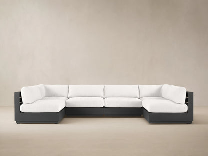 U-shaped Bal Harbour Outdoor Six-Piece Sectional with dark gray aluminum frame & light gray cushions on a paved patio.