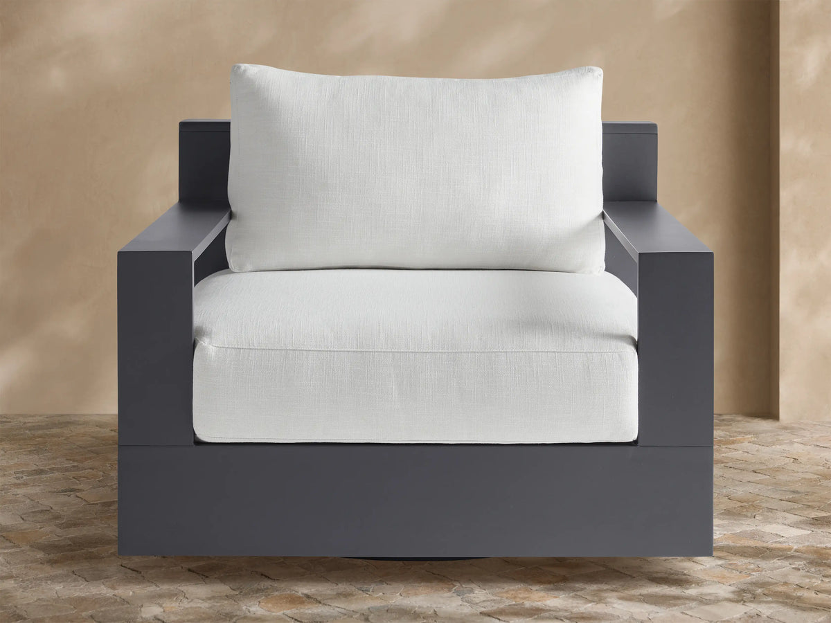 Front 3/4 view of the Bal Harbour Outdoor Aluminum Swivel Chair, featuring a charcoal aluminum frame and light beige cushions.