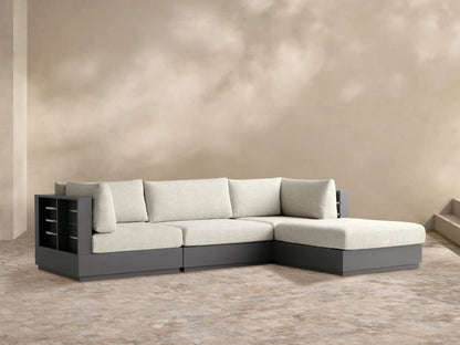 Bal Harbour L-shaped 4-pc outdoor sectional with light cream cushions & dark gray aluminum frame on a stone patio.
