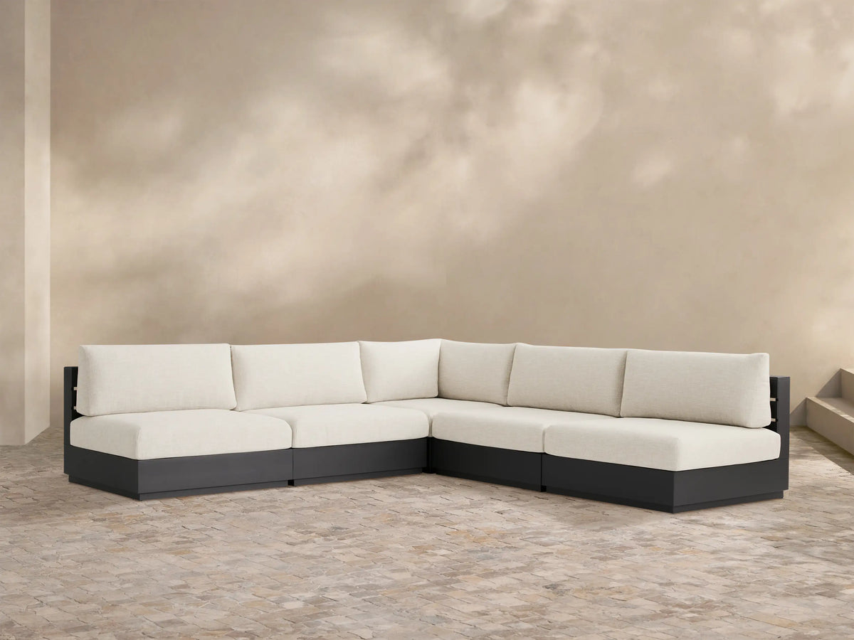 Bal Harbour Outdoor Aluminum Sectional, dark gray frame with off-white cushions, L-shaped on a light patio.
