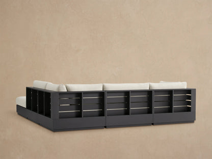 Bal Harbour Outdoor Sectional, close-up of light beige textured fabric armrest & cushions over dark aluminum frame.