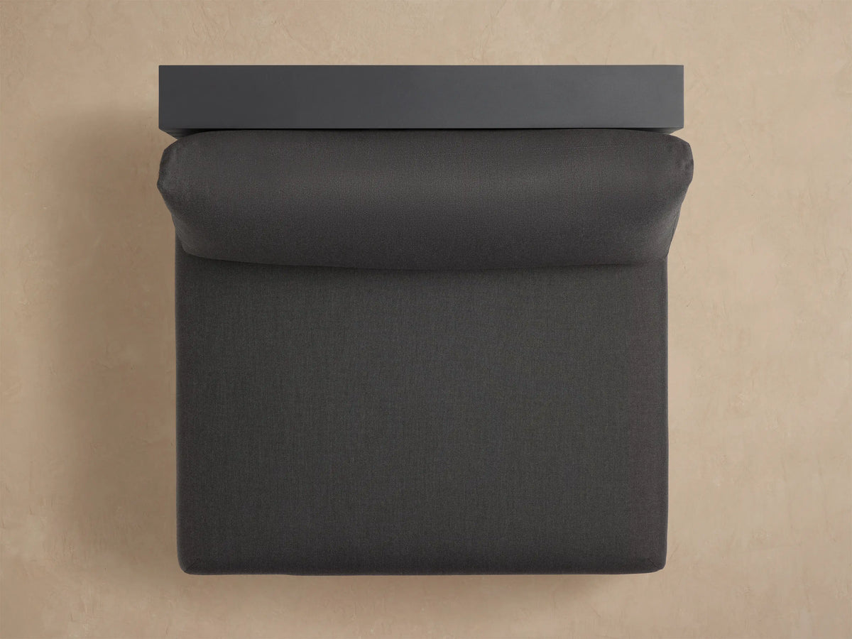 Bal Harbour Outdoor Aluminum Armless Chair, dark gray. Angled back view reveals slatted aluminum frame and plush cushions.