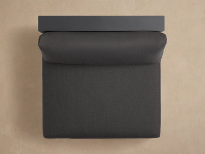 Bal Harbour Outdoor Aluminum Armless Chair, dark gray. Angled back view reveals slatted aluminum frame and plush cushions.