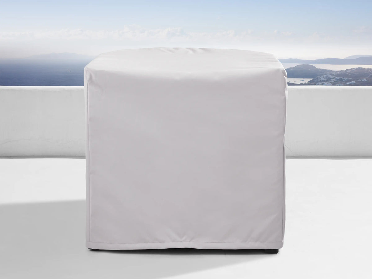Bal Harbour Outdoor Aluminum Armless Chair with light grey cushions and dark grey base on a white patio with ocean view.