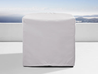 Bal Harbour Outdoor Aluminum Armless Chair with light grey cushions and dark grey base on a white patio with ocean view.
