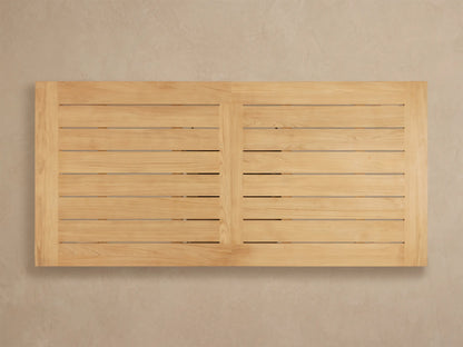 Close-up of Bal Harbour Outdoor Teak Dining Table corner, showing light golden teak wood planks with visible grain.