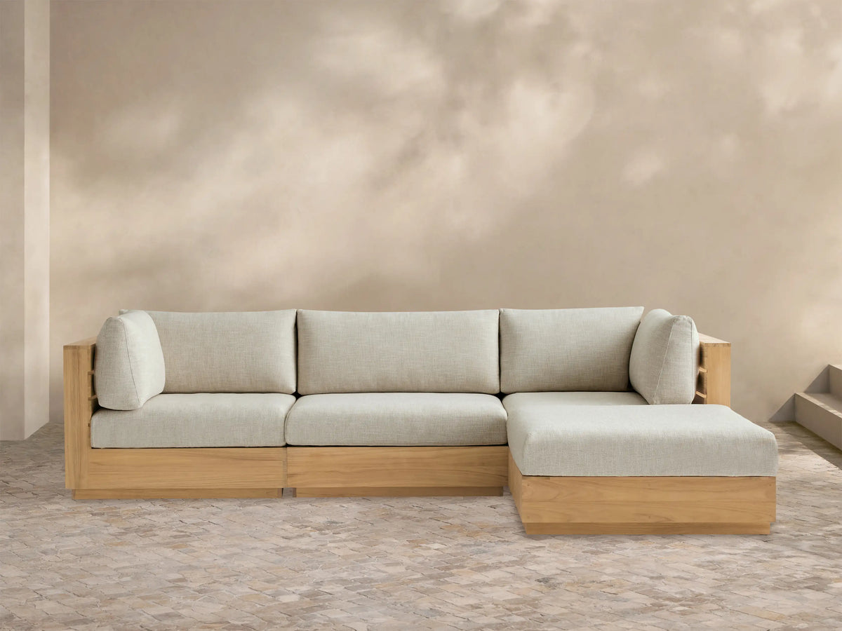Bal Harbour Outdoor Teak Four-Piece Sectional, L-shaped, with natural teak frame & Eden Oyster cushions on tiled floor.