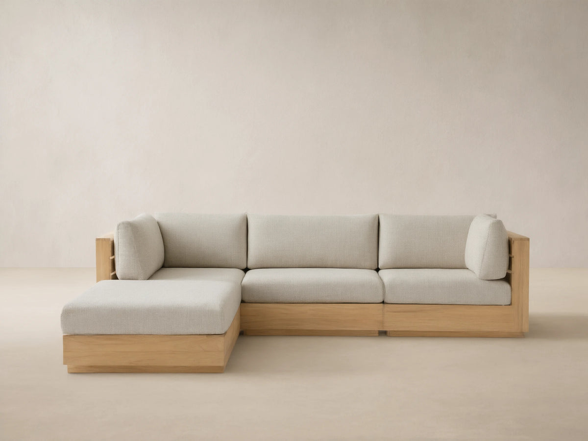 Bal Harbour Outdoor Teak Four-Piece Sectional, L-shaped, with natural teak frame & Eden Oyster cushions on tiled floor.