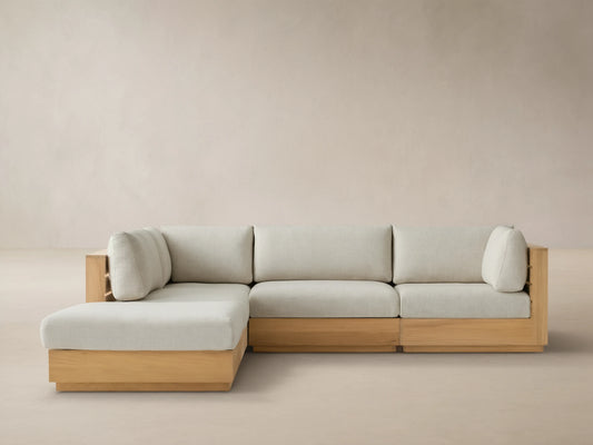 Bal Harbour Outdoor Teak Five-Piece Sectional with Ottoman, light teak frame & light beige cushions in L-shape on tiled patio.