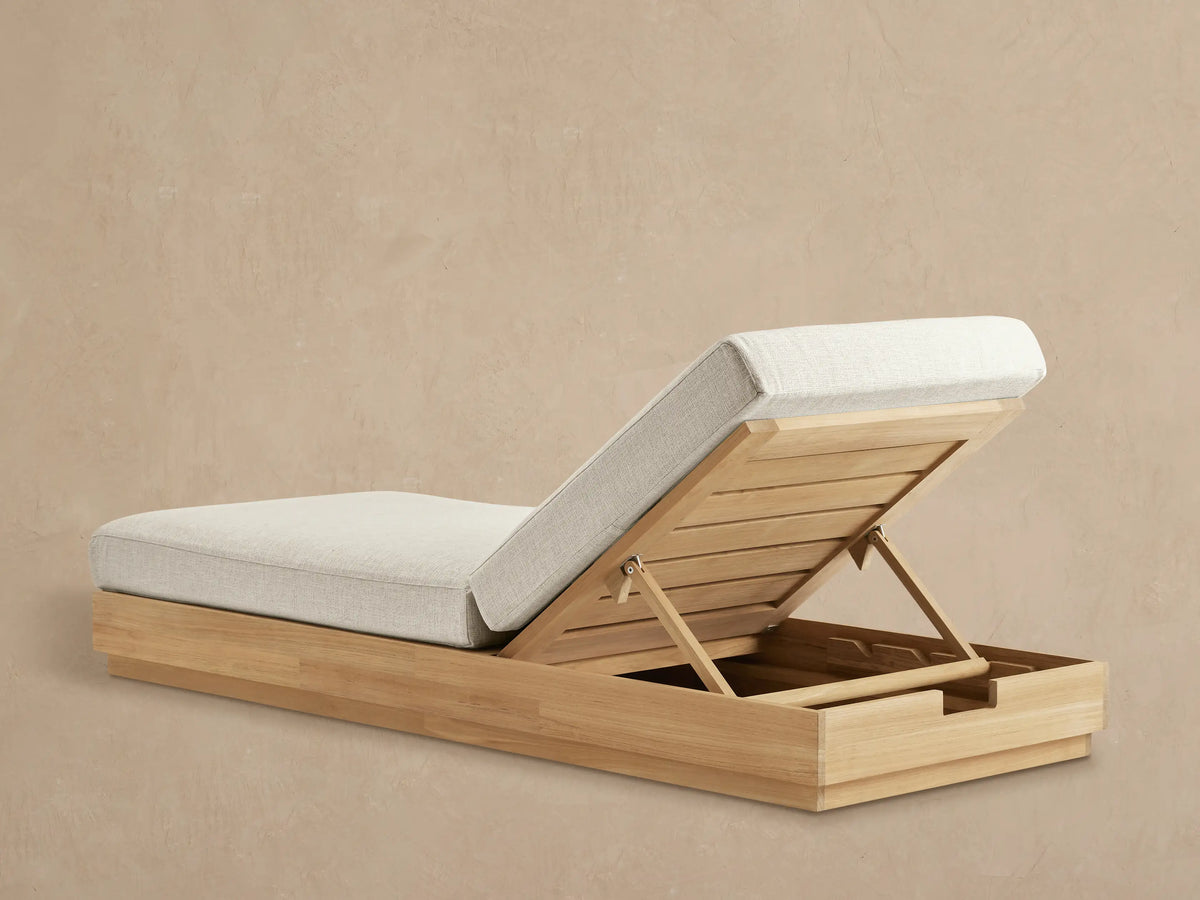 Bal Harbour Outdoor Teak Chaise: close-up of natural teak frame, headrest lifted, revealing adjustable support and light cushion.