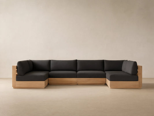 Bal Harbour Outdoor Teak Six-Piece Sectional, U-shaped, with natural light teak frame and dark gray cushions on a tiled floor.