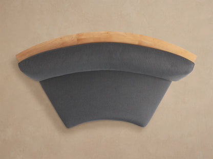 Rear view of Bal Harbour Curved Outdoor Sofa. Natural teak wood frame features built-in storage shelves. Dark gray cushions visible.