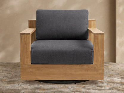 Front-right view of Bal Harbour Outdoor Teak Swivel Chair; light brown teak frame, dark gray cushions, black swivel base.