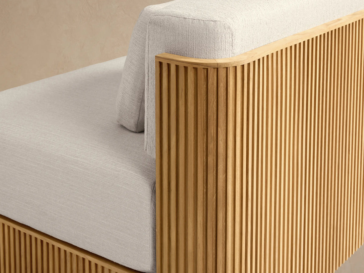 Beaumont Outdoor Teak Lounge Chair with light cream cushions and a ribbed natural teak wood base, facing forward.