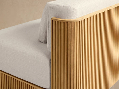 Beaumont Outdoor Teak Lounge Chair with light cream cushions and a ribbed natural teak wood base, facing forward.