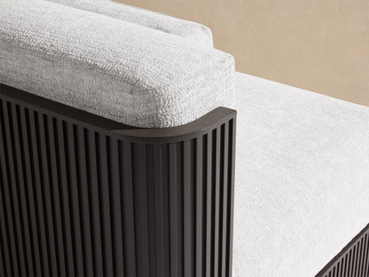 Two-piece Beaumont Outdoor Aluminum Modular Sofa, light gray upholstered cushions, dark slatted base, on a stone patio.