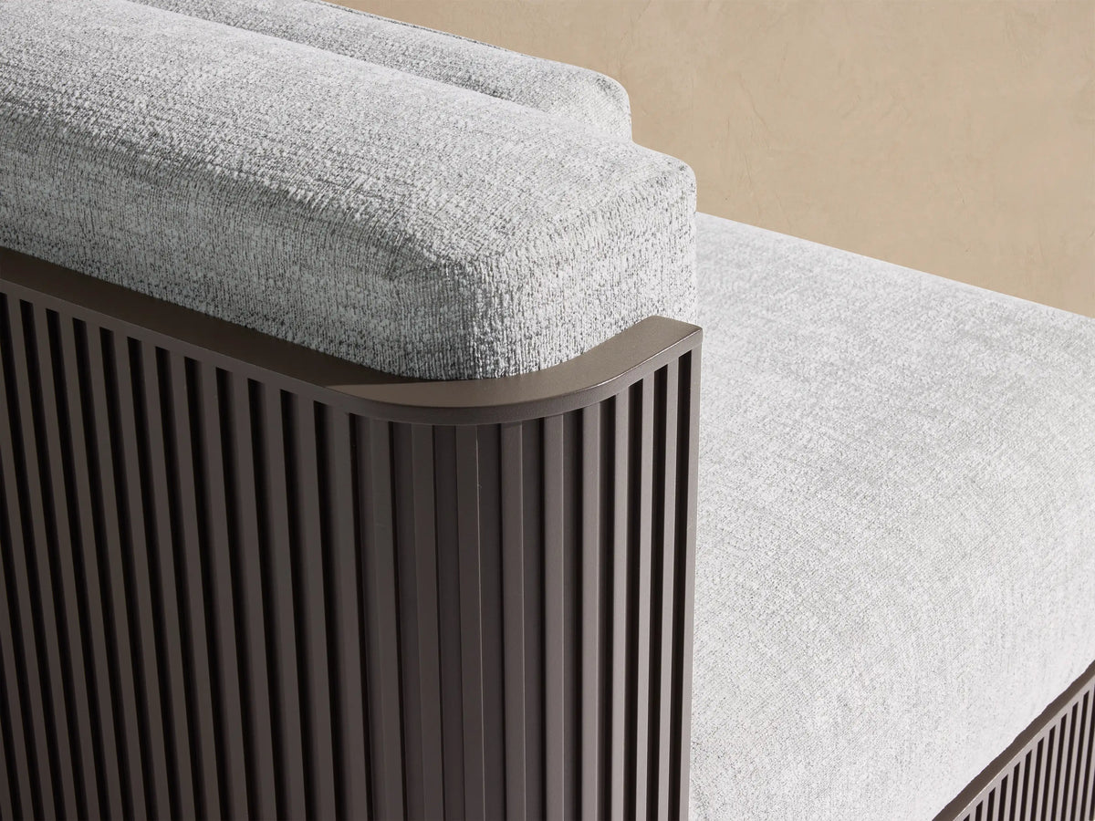 Beaumont Outdoor Aluminum Three-Piece Modular Sofa with light grey cushions and dark slatted base on a tiled patio.