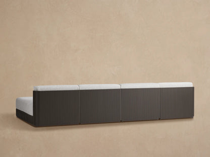 Close-up of Beaumont Outdoor Sectional with light gray textured cushions on a dark gray slatted aluminum frame.