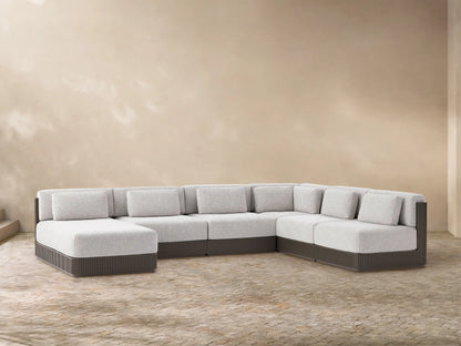 Beaumont Outdoor Aluminum Six-Piece Sectional with Chaise. Light gray cushions, dark gray slatted base, U-shaped on a tiled floor.