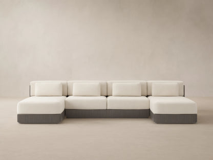 Beaumont 4-piece outdoor double chaise sectional, cream cushions, dark gray ridged aluminum base, facing forward on a patio.
