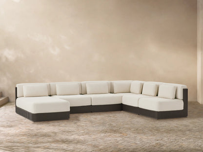 Beaumont six-piece L-shaped outdoor sectional with cream cushions, dark brown slatted aluminum base, on a stone patio.