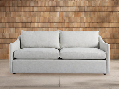 Light gray Branson Outdoor Sofa with two seat and two back cushions, modern clean lines, against a wooden shingle wall.