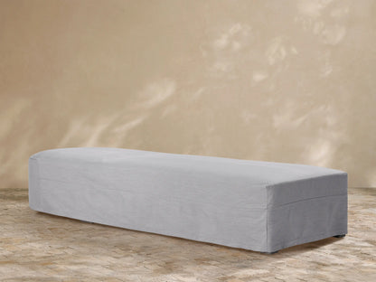 White Canyon Outdoor Collection Covers protect an outdoor sofa, ottoman, and chair on a stone patio.