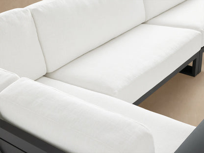 Canyon Outdoor Aluminum Three-Piece Sectional, L-shaped, with dark gray frame and white cushions on a tiled patio.