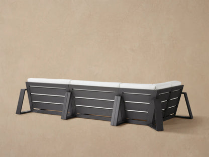Canyon Outdoor Aluminum Three-Piece Sectional, close-up of corner with white textured cushions & dark gray frame.
