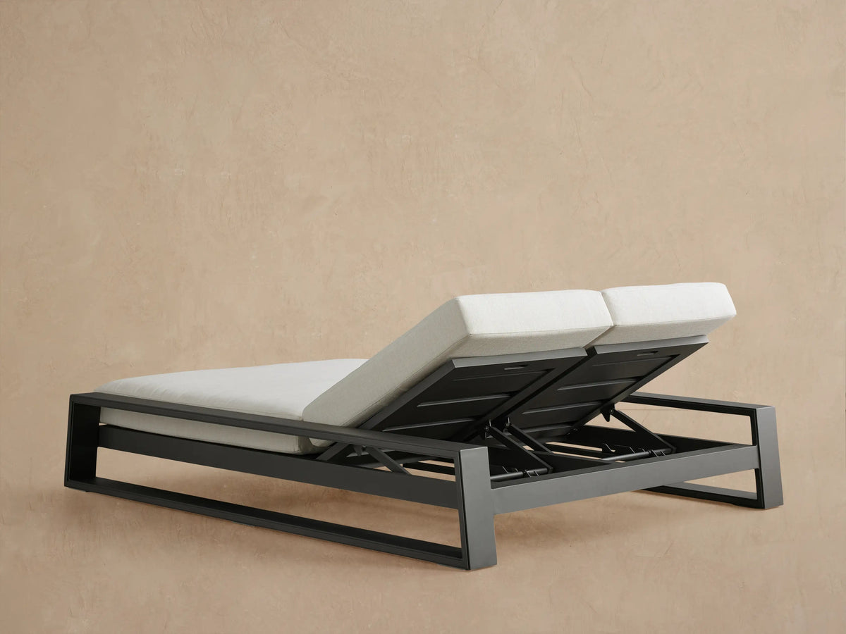 Canyon Outdoor Aluminum Double Chaise close-up: Dark gray frame and adjustable back mechanism under a light gray cushion.