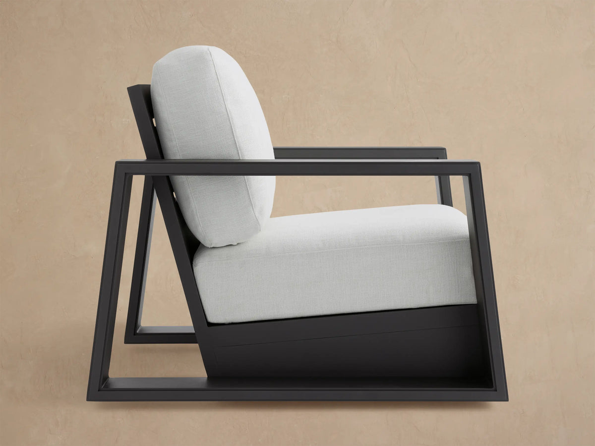 Canyon Outdoor Aluminum Swivel Chair, dark gray slatted frame & box armrests, light beige cushions, angled back-right.