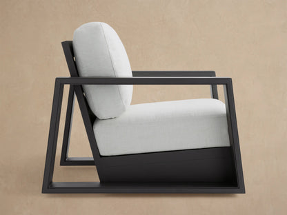 Canyon Outdoor Aluminum Swivel Chair, dark gray slatted frame & box armrests, light beige cushions, angled back-right.