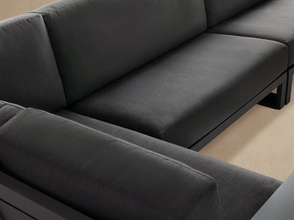 Canyon Outdoor Aluminum Three-Piece Sectional, L-shaped, with dark gray cushions and a charcoal aluminum frame on a paved patio.