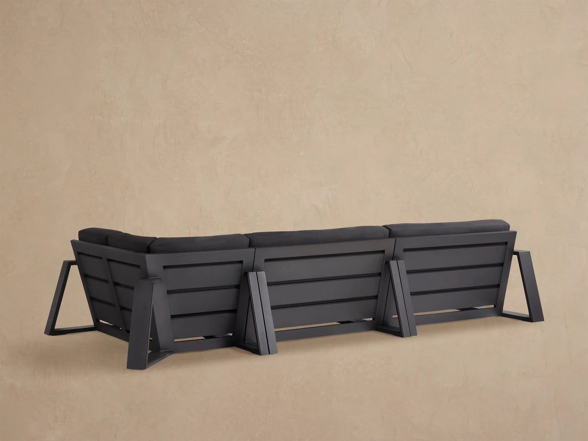 Close-up of dark grey Canyon Outdoor Aluminum Sectional, showing thick cushions and dark aluminum frame.
