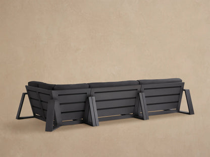 Close-up of dark grey Canyon Outdoor Aluminum Sectional, showing thick cushions and dark aluminum frame.