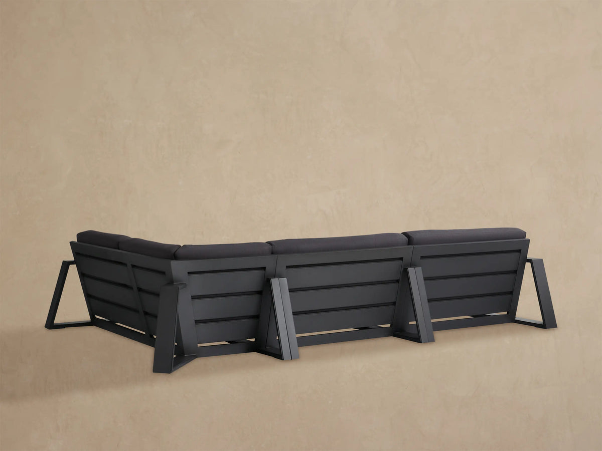 Canyon Outdoor Aluminum Sectional, dark grey cushions & black frame, angled close-up view showing multiple sections.