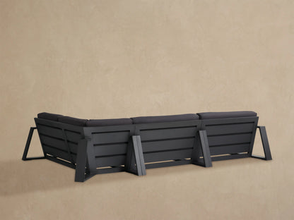 Canyon Outdoor Aluminum Sectional, dark grey cushions & black frame, angled close-up view showing multiple sections.