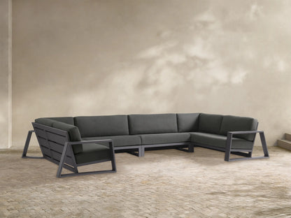 Canyon Outdoor Aluminum Four-Piece Sectional, dark gray cushions on visible charcoal aluminum frames, U-shaped on patio.