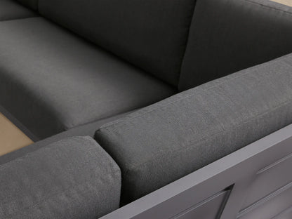 Canyon Outdoor Aluminum Four-Piece Sectional with dark gray frame and cushions, arranged in a large U-shape on a patio.