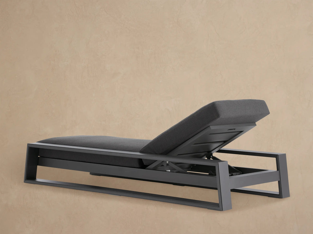 Close-up of Canyon Outdoor Aluminum Chaise, dark gray cushion & frame. Backrest elevated, showing adjustable mechanism.