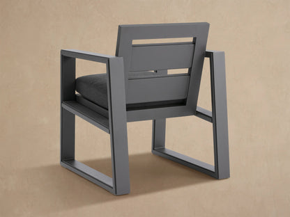 Angled close-up of a modern Canyon Outdoor Aluminum Dining Arm Chair with dark gray frame and charcoal seat cushion.