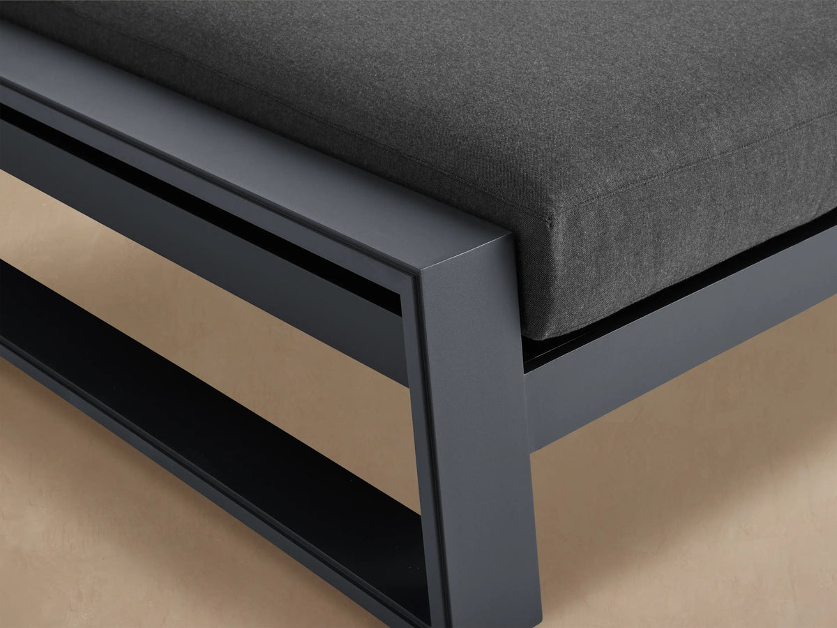 Side view of a Canyon Outdoor Aluminum Double Chaise with dark gray frame and dark gray cushions, one backrest elevated.